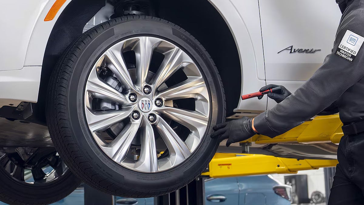 Certified GM Technician inspecting a car